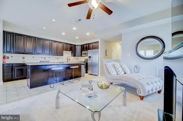 a living room with granite countertop furniture and kitchen view