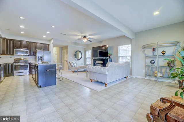 a living room with furniture and kitchen view