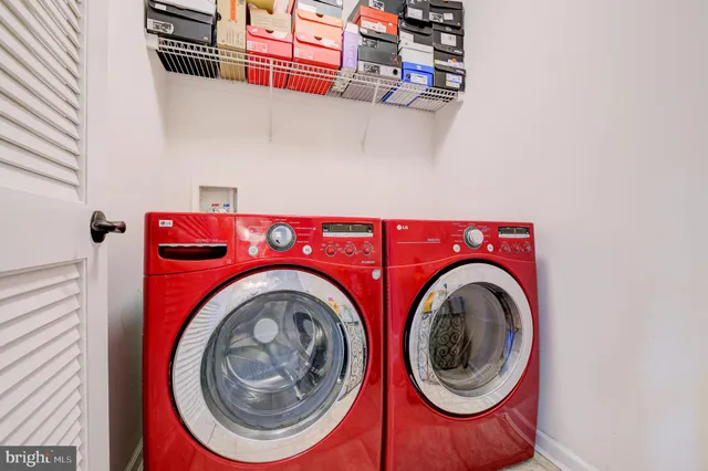 a bedroom with a bed a chandelier and windows
