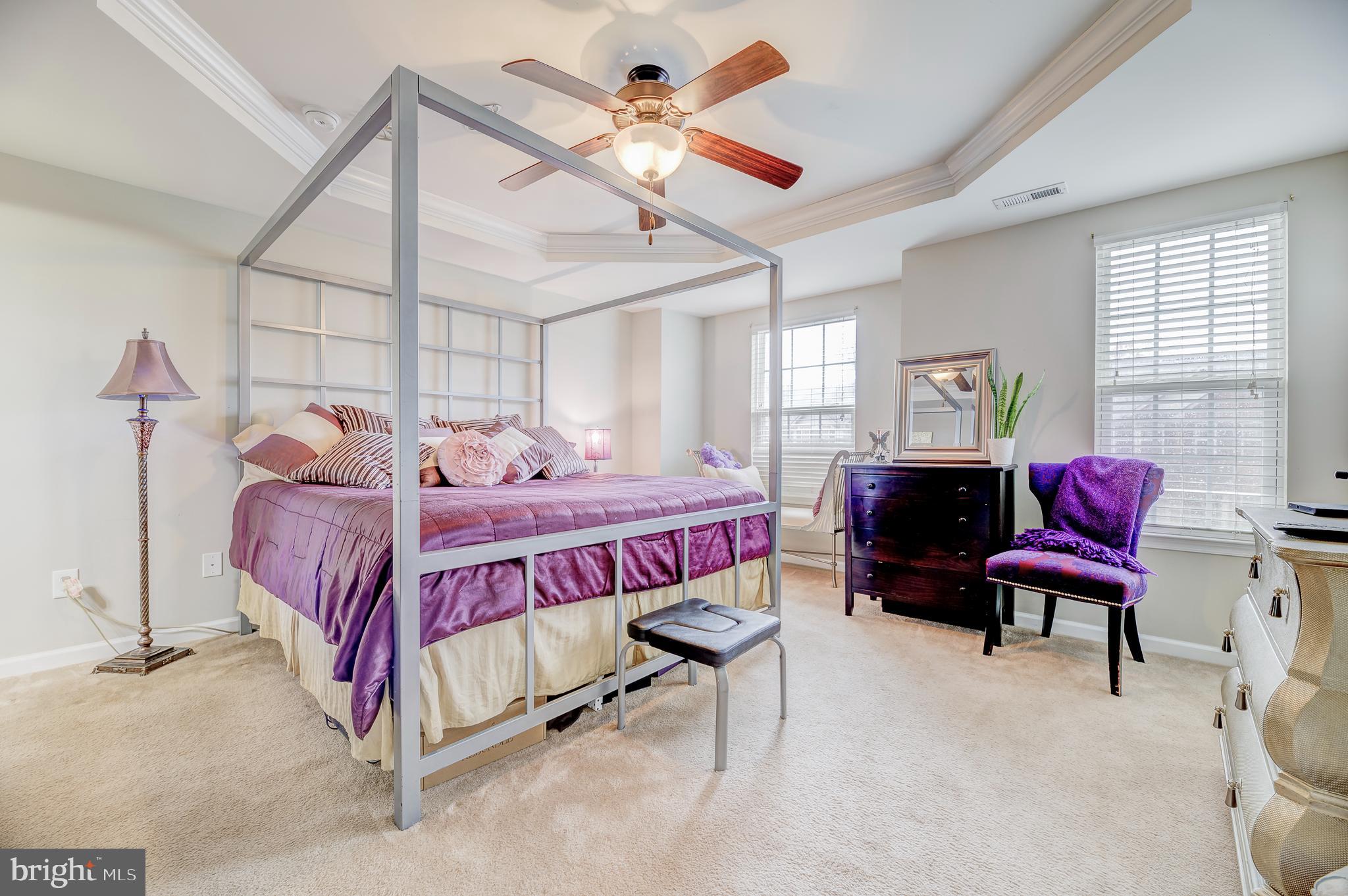 81 Sundance Drive Hamilton, NJ 08619 - Photo 23 of 44 a bedroom with a bed a chandelier and windows
