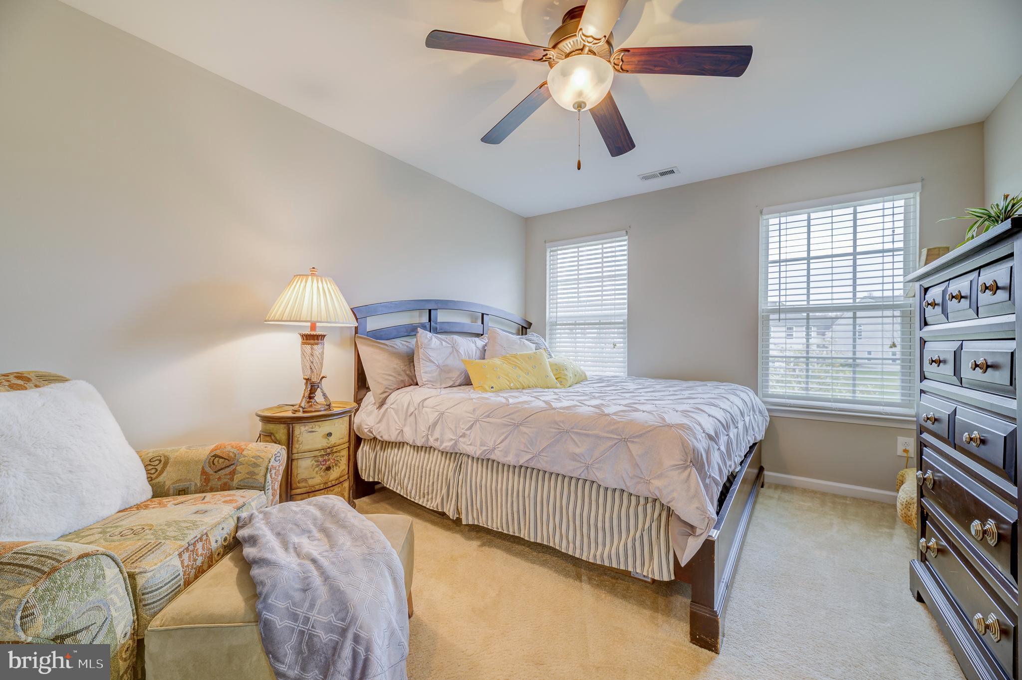 81 Sundance Drive Hamilton, NJ 08619 - Photo 27 of 44 a bedroom with a bed a window and a chandelier