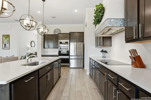a kitchen with a sink stainless steel appliances and cabinets