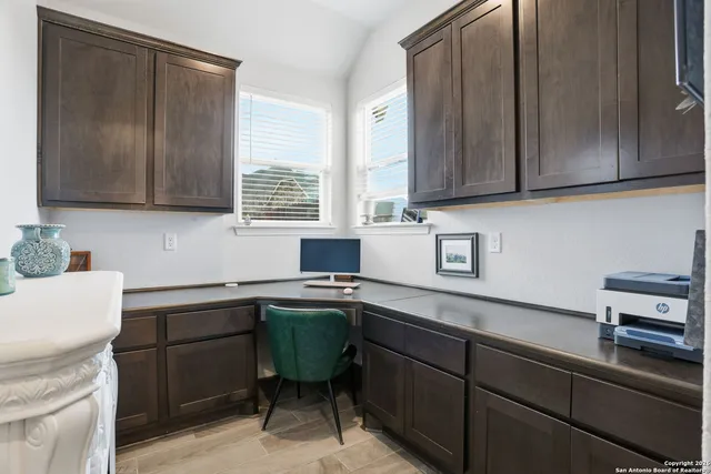 a kitchen with a sink cabinets and wooden floor