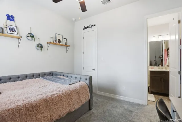 a bedroom with a bed and cabinets