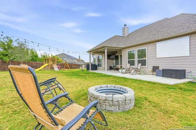 a view of swimming pool with outdoor seating and yard
