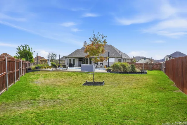 a swimming pool with outdoor seating and yard