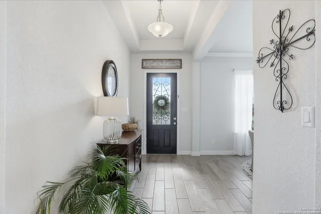 a view of a room that has a table and a chair with wooden floor