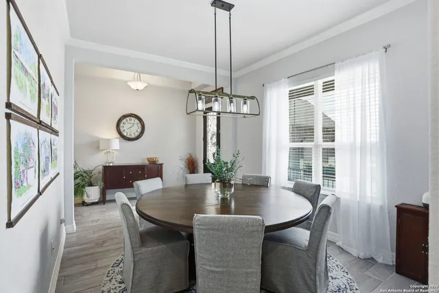 a dining room with furniture a chandelier and window