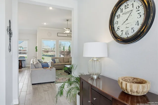 a living room with furniture and a mirror