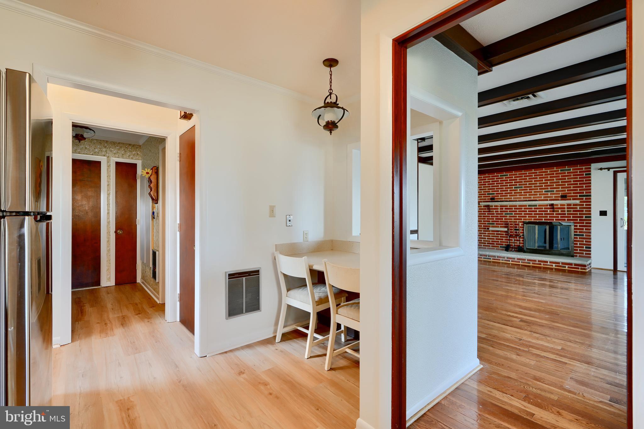 1924 Cedar Road Pasadena, MD 21122 - Photo 12 of 43 a view of a hallway with wooden floor and livingroom with furniture