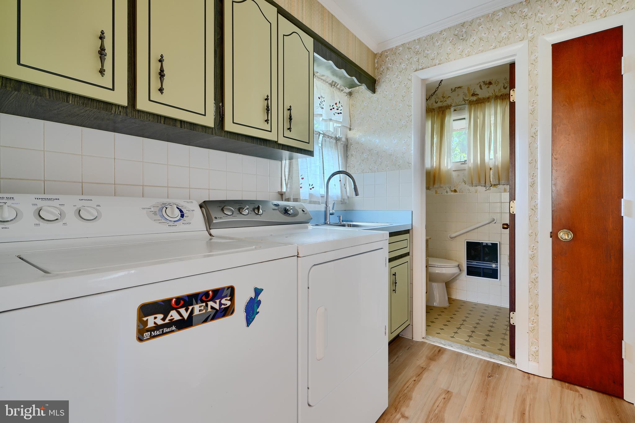 1924 Cedar Road Pasadena, MD 21122 - Photo 19 of 43 a kitchen with stainless steel appliances granite countertop a sink and cabinets