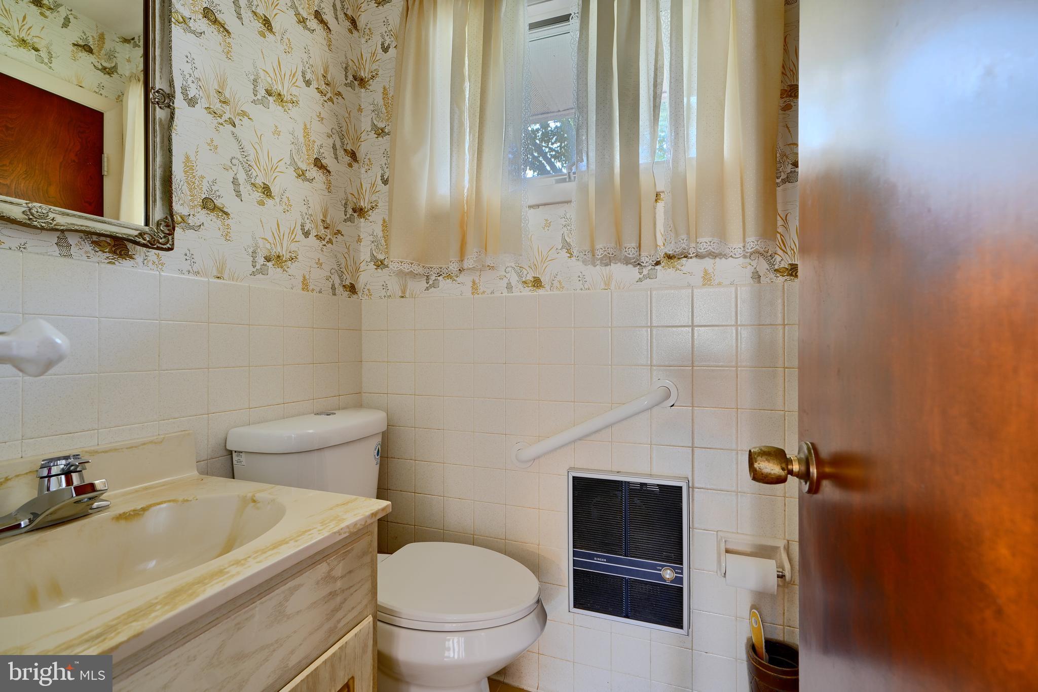1924 Cedar Road Pasadena, MD 21122 - Photo 20 of 43 a bathroom with a sink toilet and shower