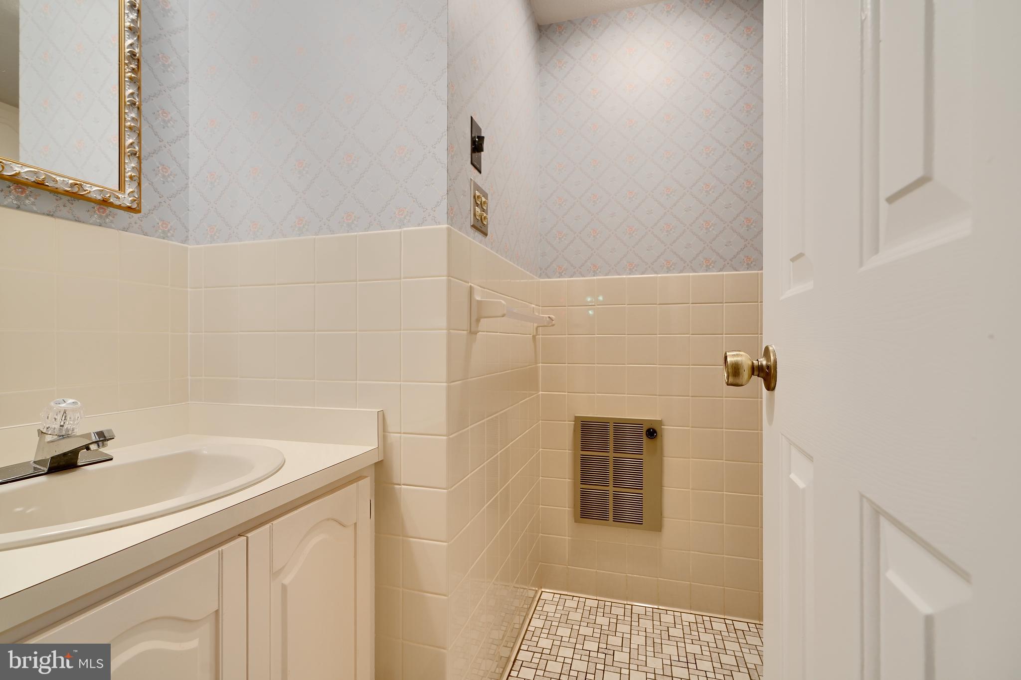 1924 Cedar Road Pasadena, MD 21122 - Photo 28 of 43 a bathroom with a sink and a mirror