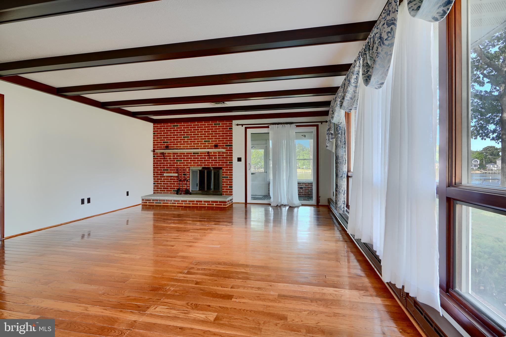 1924 Cedar Road Pasadena, MD 21122 - Photo 5 of 43 a view of a hallway with wooden floor and a cabinet