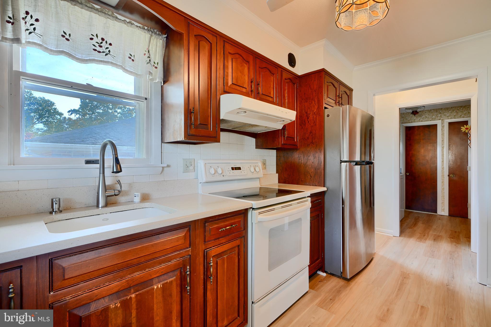 1924 Cedar Road Pasadena, MD 21122 - Photo 9 of 43 a kitchen with stainless steel appliances granite countertop a sink refrigerator and cabinets