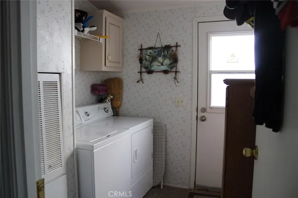 a bedroom that has a bed and a chandelier