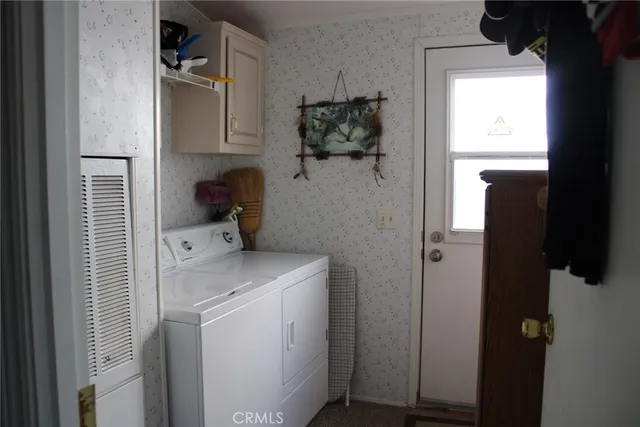 a bedroom that has a bed and a chandelier