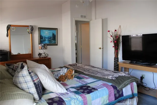 a bedroom with a bed and a flat screen tv