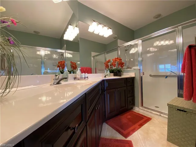 a bathroom with a sink mirror and a bath tub