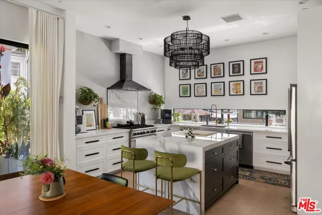 a kitchen with stainless steel appliances a sink stove and cabinets