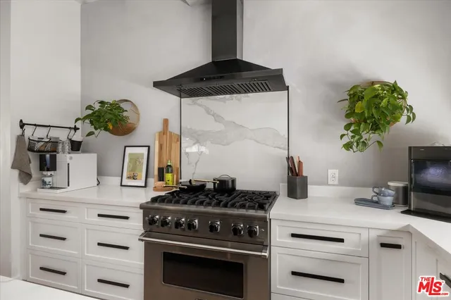 a kitchen with a stove and cabinets