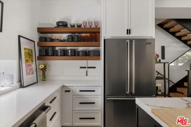 a kitchen with stainless steel appliances a refrigerator and a stove