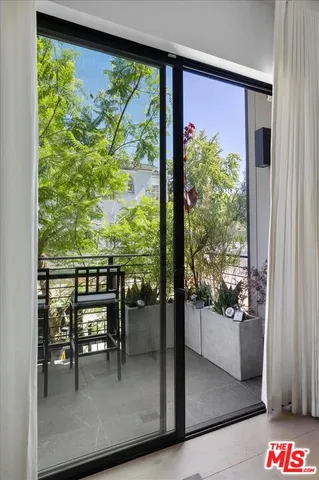a view of a porch with a table and chairs