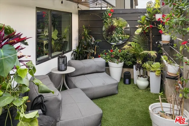 a view of a backyard with garden and patio