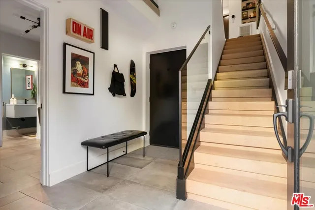 a view of staircase with lots of frames on wall and stairs