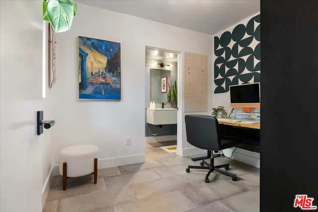 a view of a workspace with furniture and a potted plant