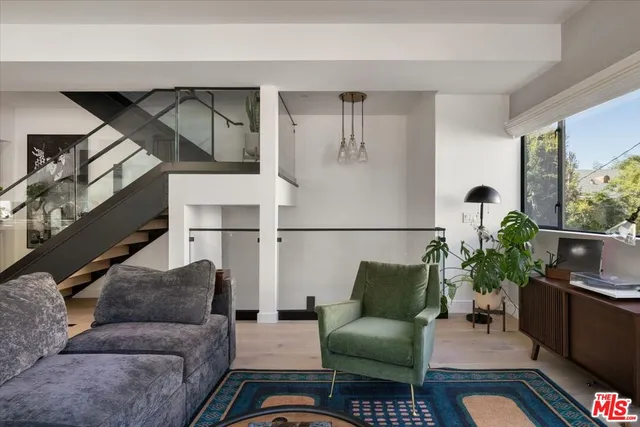 a living room with furniture and a potted plant