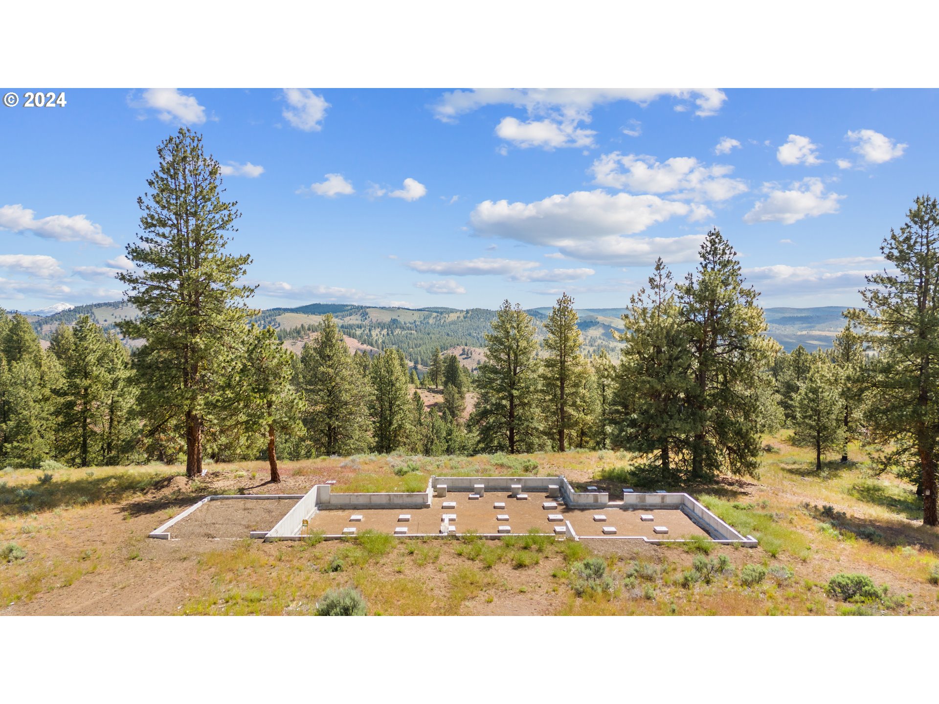 30169 Horseshoe Loop, Unit S15 Seneca, OR 97873 - Photo 3 of 9 a view of a swimming pool with an outdoor space and seating area