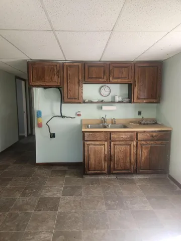 a kitchen with a stove a sink and a refrigerator