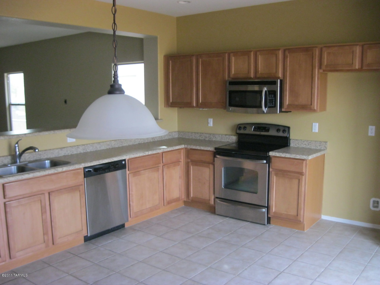 21088 East Treasure Road Red Rock, AZ 85145 - Photo 4 of 6 a kitchen with stainless steel appliances granite countertop a stove a sink and a microwave