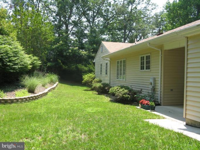 11120 Cove Lake Road Lusby, MD 20657 - Photo 13 of 28 Backyard- landscaping + patio
