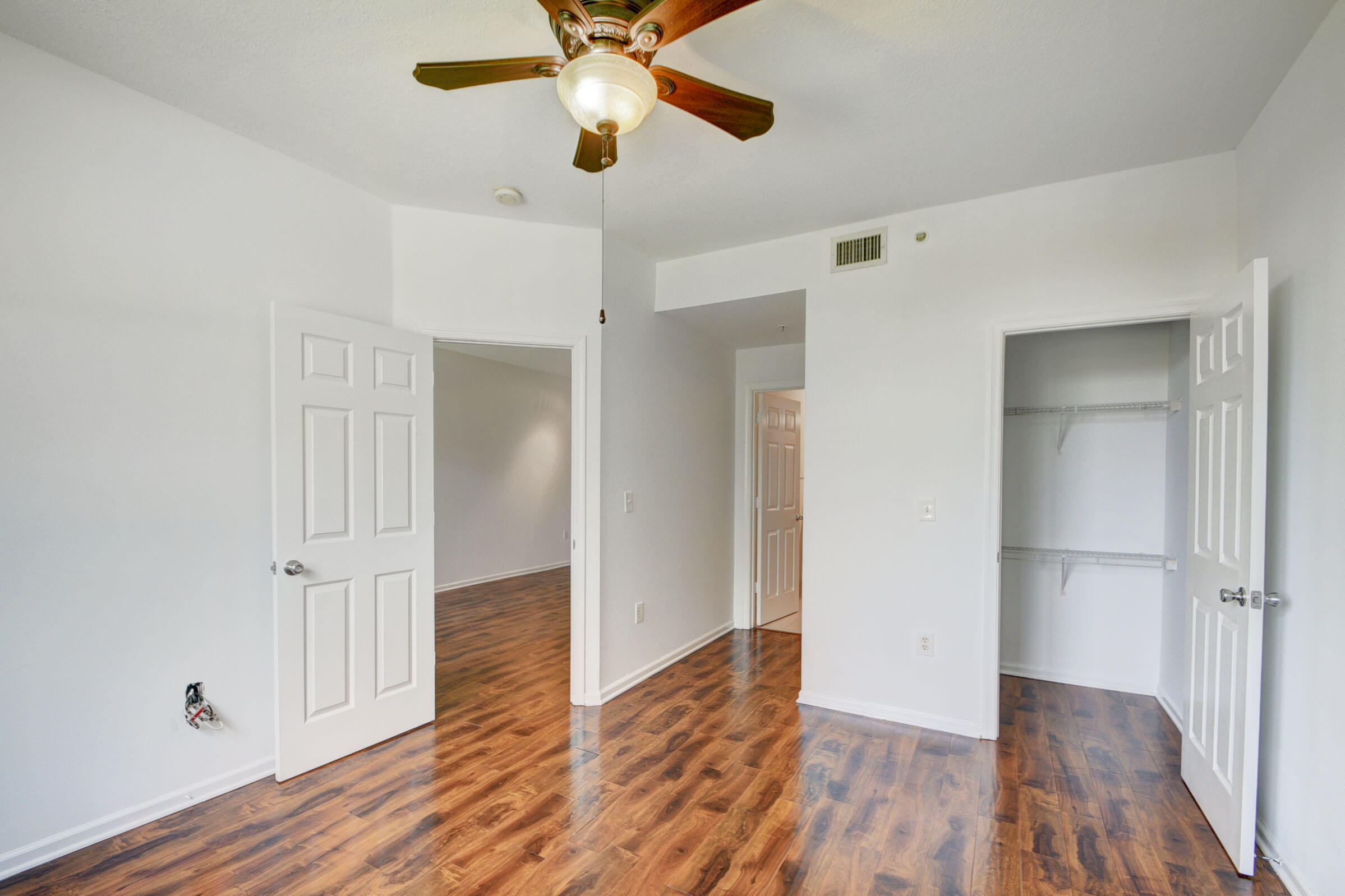 2020 Greenview Shores Boulevard, Unit 108 Wellington, FL 33414 - Photo 12 of 25 wooden floor in an empty room with a window