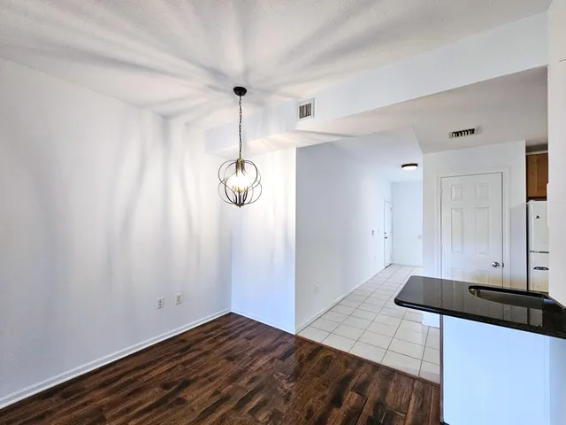 a view of a kitchen with wooden floor and window