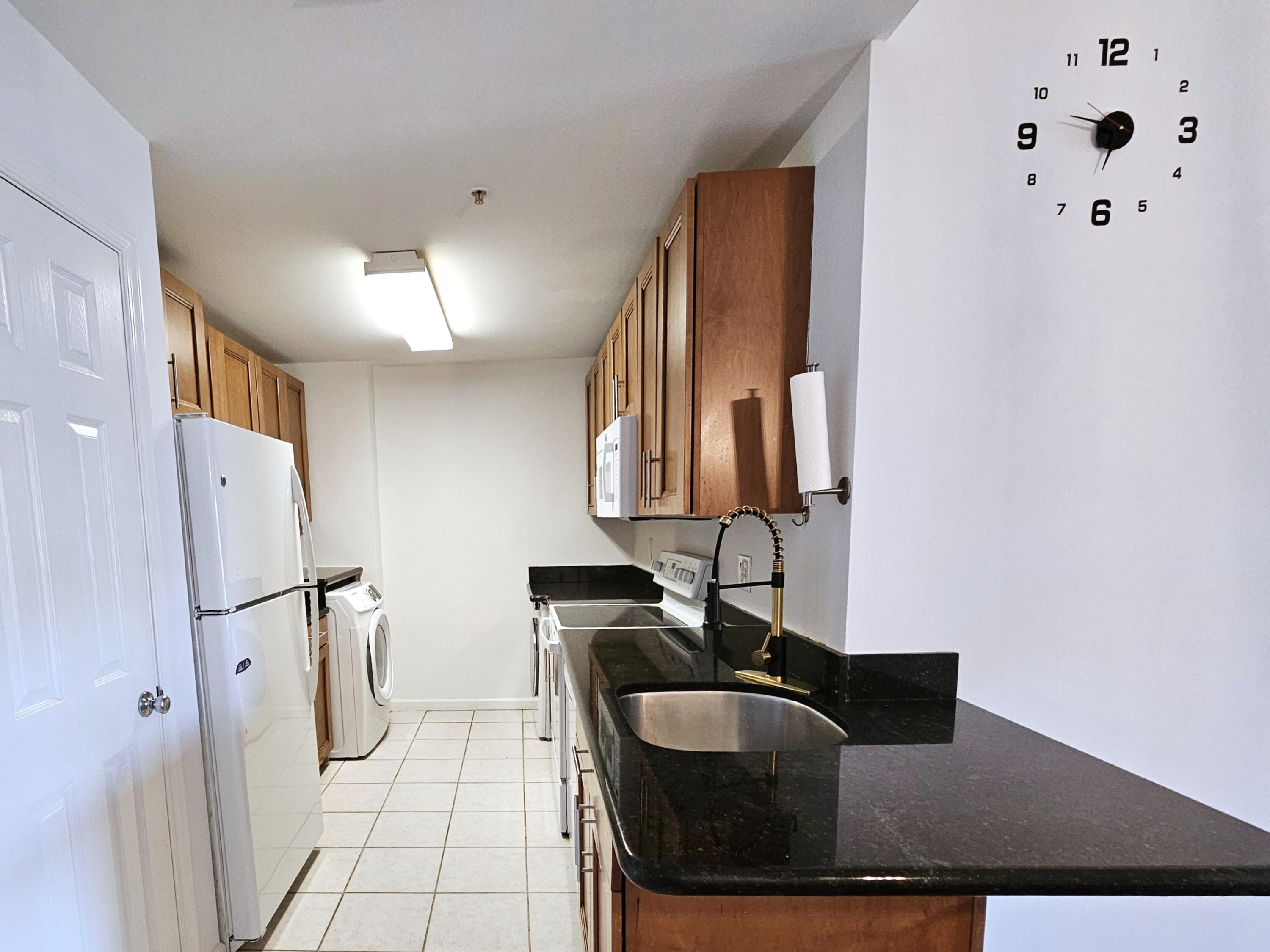 2020 Greenview Shores Boulevard, Unit 108 Wellington, FL 33414 - Photo 7 of 25 a bathroom with a sink and a mirror