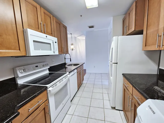 a kitchen with a sink a stove and a refrigerator