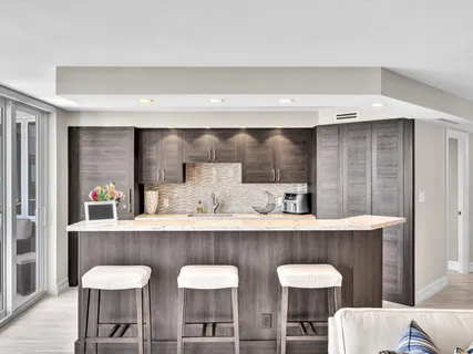 a bathroom with a granite countertop sink a mirror and shower