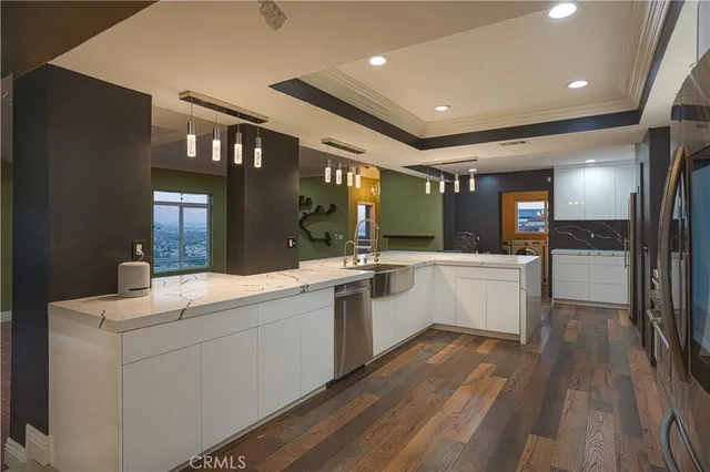 a kitchen with a sink a counter space and stainless steel appliances