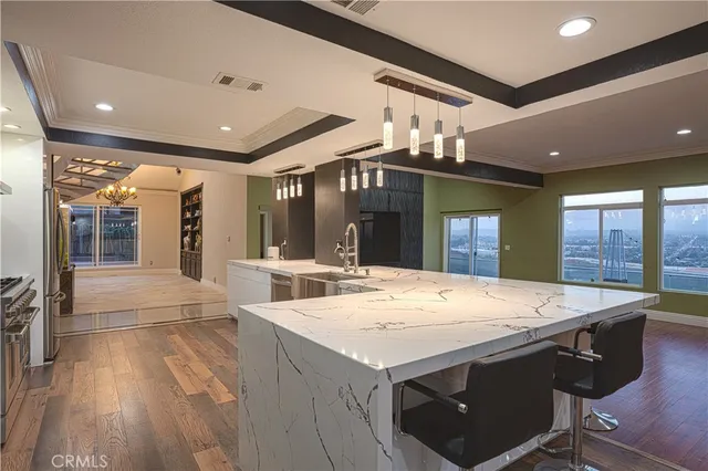 a open kitchen with a sink and refrigerator