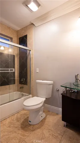 a view of a house chairs and deck in the backyard