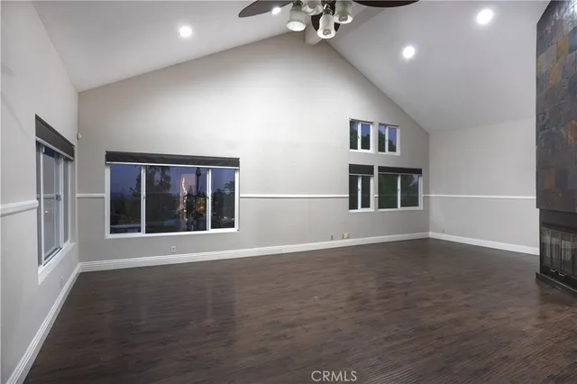 a view of a hallway of kitchen and hall with wooden floor