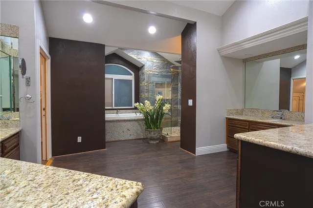 a bathroom with a granite countertop sink and a mirror