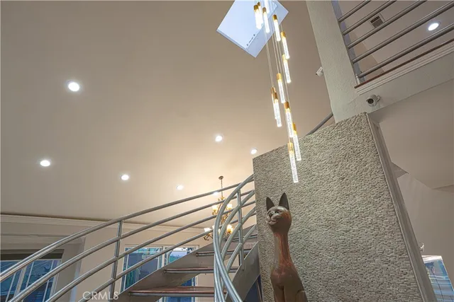 a large white kitchen with a refrigerator a sink dishwasher a stove and a dining table with wooden floor