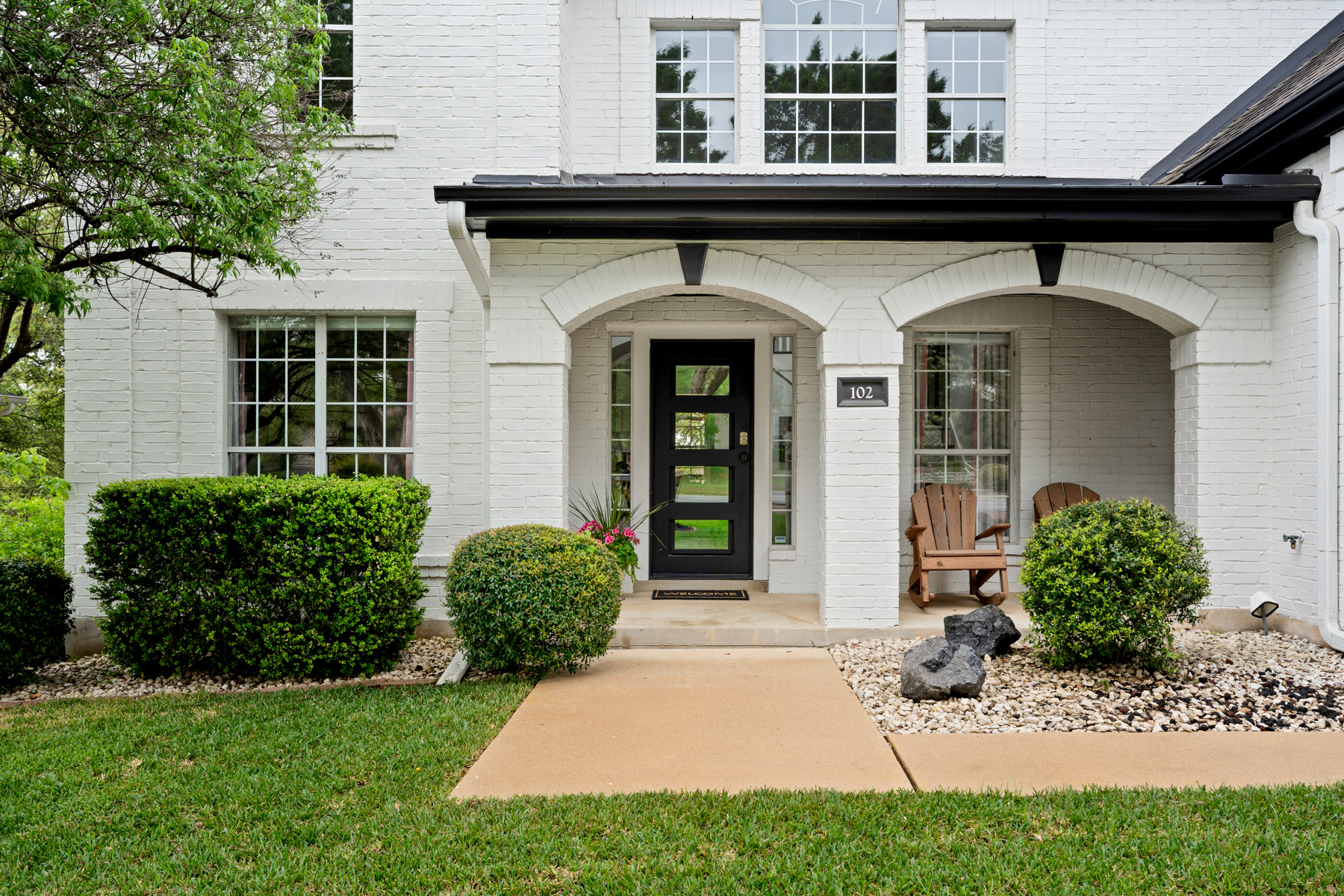 102 Hurst Creek Road Lakeway, TX 78734 - Photo 2 of 29 a front view of a house with garden