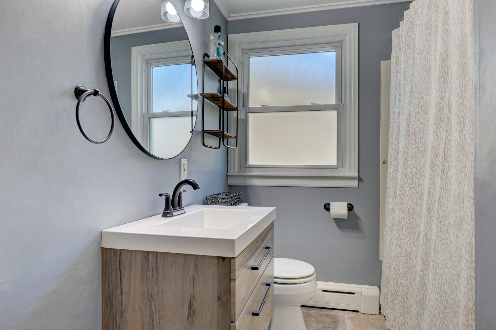 407 West Taylor Road Lombard, IL 60148 - Photo 17 of 33 a bathroom with a sink a toilet and a mirror