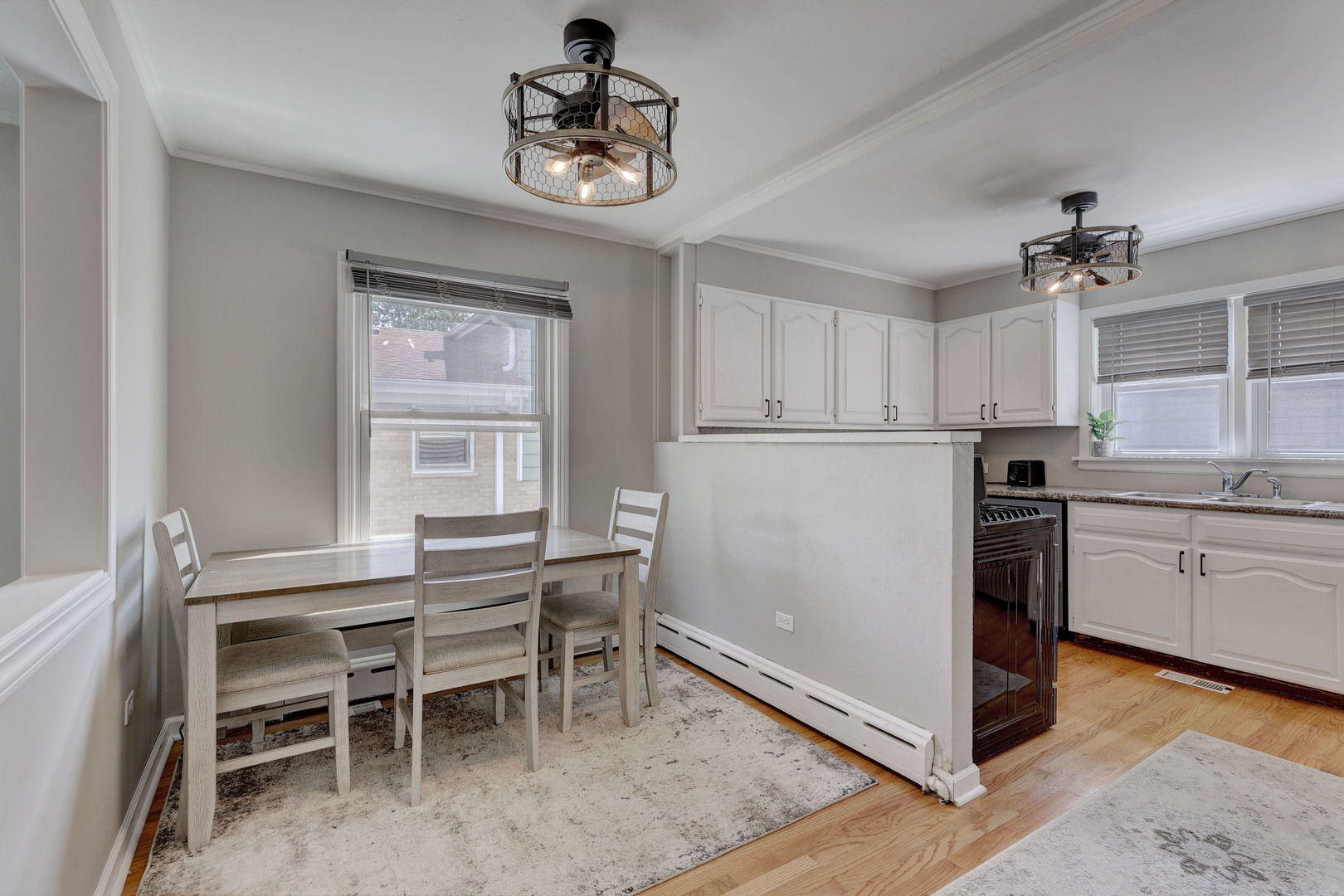 407 West Taylor Road Lombard, IL 60148 - Photo 9 of 33 a kitchen with a table chairs refrigerator and cabinets
