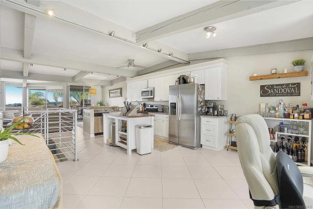 a kitchen with a sink a stove and cabinets
